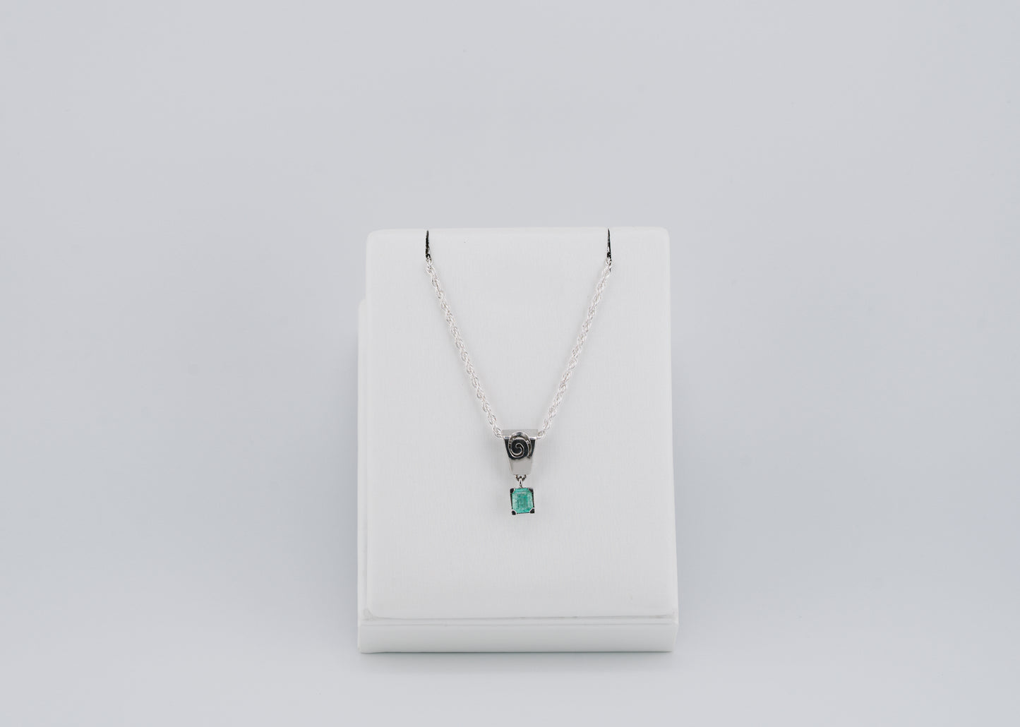 The Spiral of Memory Pendant – 0.43 Colombian Emerald – 950 Sterling Silver