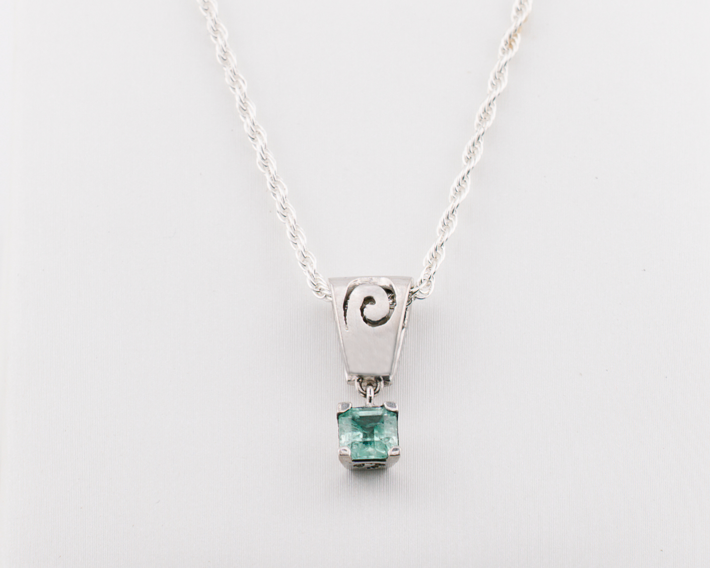 The Spiral of Memory Pendant – 0.61 Colombian Emerald – 950 Sterling Silver