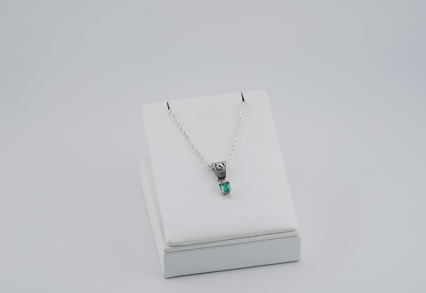 The Spiral of Memory Pendant – 0.43 Colombian Emerald – 950 Sterling Silver