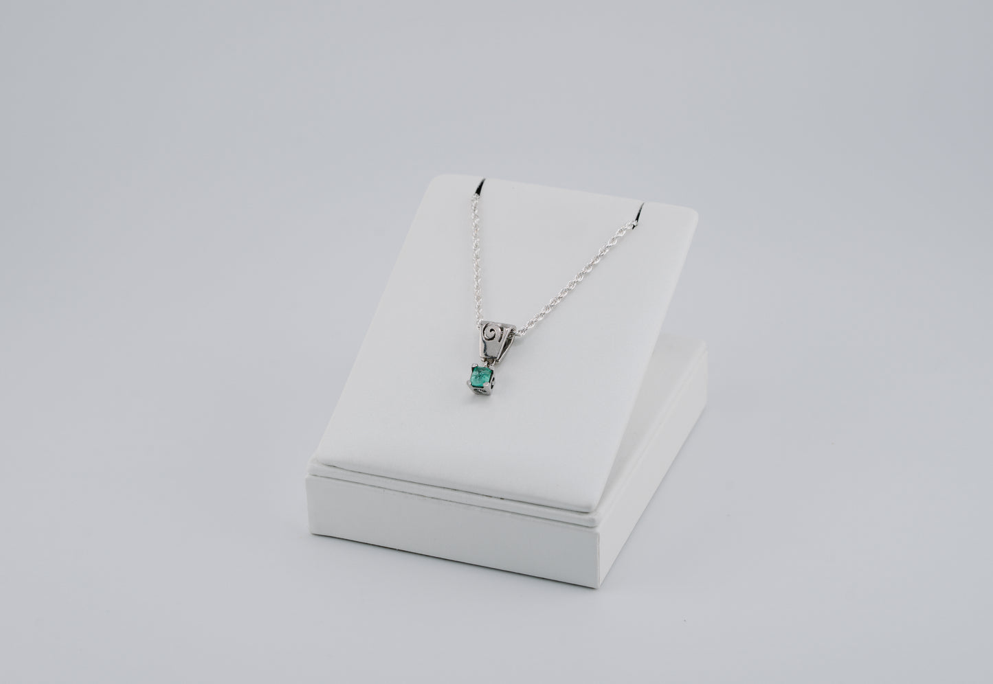 The Spiral of Memory Pendant – 0.43 Colombian Emerald – 950 Sterling Silver